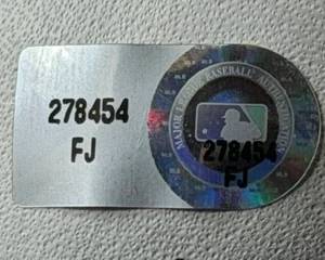 Here's the close up. You can go to their website and confirm this sticker belongs to a signed Nolan Ryan ball. It checks out!