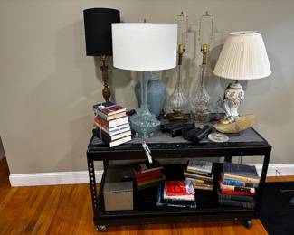 Murano aqua glass lamp, gun safe, various first editions, black table. . .