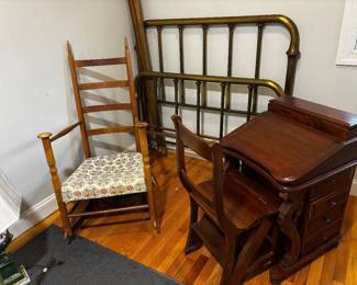 Antique brass headboard and footboard with vertical spindles and caters. 20th-century Shaker-style shawl back rocking chair. Antique mahogany Davenport writing desk with drawers and hinged writing surface.