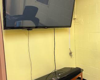 LG flatscreen with sound bar and speakers