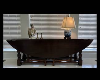 Monumental early 20th century English Wake gate leg dark stained solid oak dining table