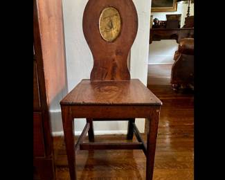 19thc. English Armorial Hall Chair with central painted crest of arm holding axe.
