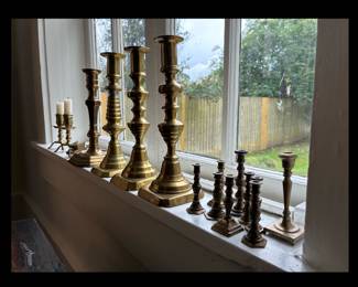 Antique brass candle sticks, and a collection of miniature brass candlesticks.