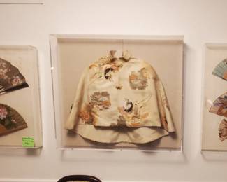Brocade cape and framed fans in lucite 