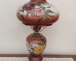 Hurricane-style table lamp with hand painted floral glass globes and brass base