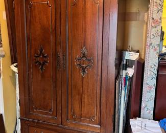Large entertainment center, used as coat closet in foyer