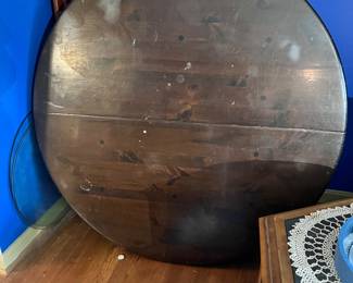 Large heavy wooden table, curvy legs, two leaves. 50” diameter, 2.5” thick