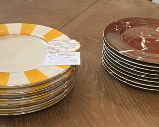 House Este Ceramiche e Porcellane hand-painted yellow and white plates from Italy.  Villeroy & Boch porcelain charger plates oxblood red marble pattern; produced in Luxemburg.