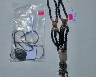 Brass-tone figural w/ light green disc pendant, black bead strand, Round painted stone w/ black cord