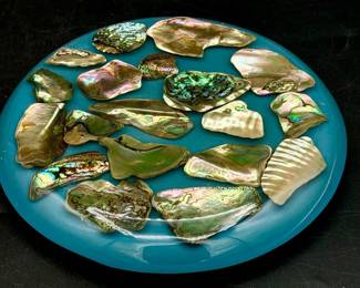 vintage blue lucite trivet featuring iridescent abalone shell fragments