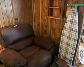 brown chair, ironing board, and decor