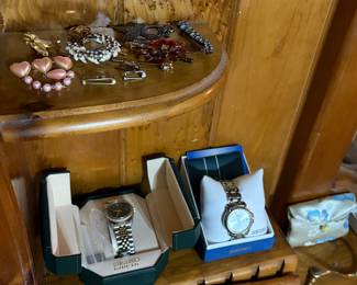 men and woman's watches and various pins and broaches