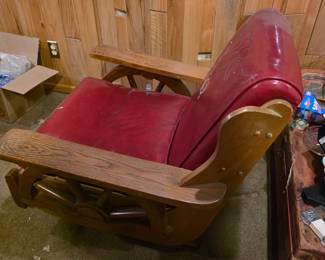 AI Overview +3 This is a vintage 1950s western-style wagon wheel rocking chair featuring red vinyl upholstery with stitched horse head details and a light wood frame.This style of furniture, often referred to as "dude ranch" or "cowboy" furniture, was popularized in the 1950s and was commonly sold through mail-order catalogs like Sears or Montgomery Ward.