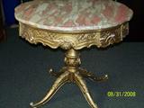 Gold table with marble top
Approximately 3 ft diameter