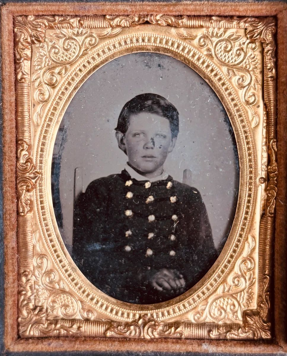 Civil War era daguerreotype of young boy dressed in jacket with braid and gilt buttons (possibly military school)...