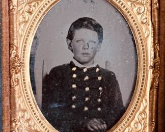 Civil War era daguerreotype of young boy dressed in jacket with braid and gilt buttons (possibly military school)...