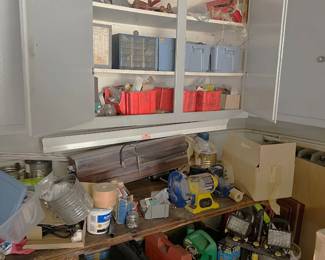 There are a number of tools with cases on the bottom shelves here (a bit difficult to see) with another cabinet and more tools and supplies.