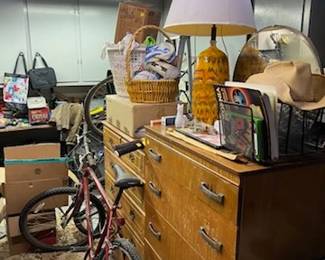 This picture shows the dressers you saw in a previous photo, but also at least one bicycle.