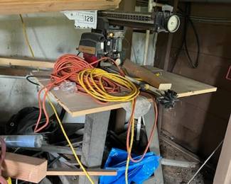 It took me a moment to realize the main subject in this photo is a standing radial arm saw. Of course, the extension cords are also worth a look.