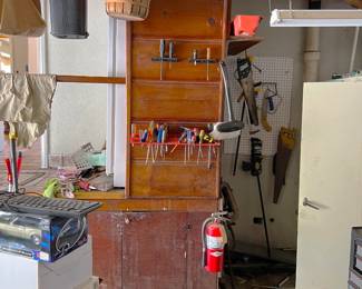 It is a bit dark in the corner, but there are some hand tools to the right of the screwdriver storage (picture center).