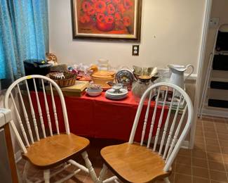 A pair of matching chairs can be seen here. The still-life on the wall adds a good bit of color.
