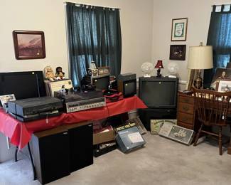 On the bottom left are a pair of Panasonic Thrusters speakers, which were highly regarded for their price range in the 1970s and 80s. But look around at the other televisions, LPs, lamps, a desk, desk chair, and stereo receiver.