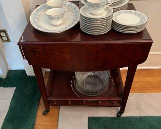 Off to the side in the dining room is a rolling cart with flip-up wings.