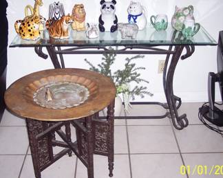 Glass top side table, approx. 50" wide  $65.  Antique Brass table top w/ carved wood stand, $45  Asst. animal collectible pitchers $ 5