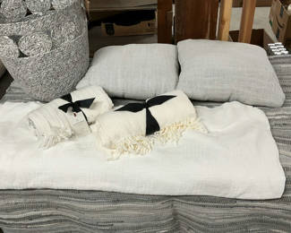 Lot 128: White and Gray Textile Set with Cushions, Throws, Rug, and Storage Basket
