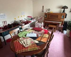 Dining room table set, player piano, small desk (matches dining room set), glass/wood display hutch, placemats, linen sheets, napkins, towels and comforters