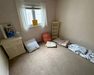 Nightstand, small shelf, pillows and comforters