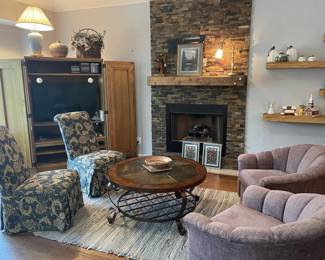 Living area - Swivel Lavender chairs; blue high back chairs; coffee table; Entertainment Cabinet
