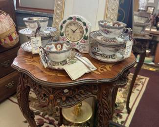 frames, tea cups and saucers, mantle clock, table