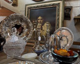 silver-plate serving pieces, framed art