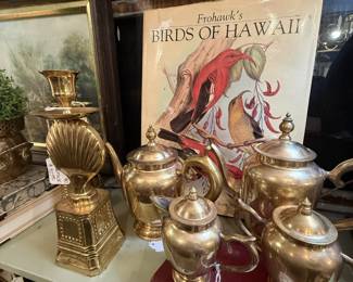 brass candlesticks, coffee table books, tea set,