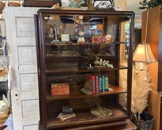 beautiful dark wood solid wood book shelf with varied shelf sizes and detail curved edges