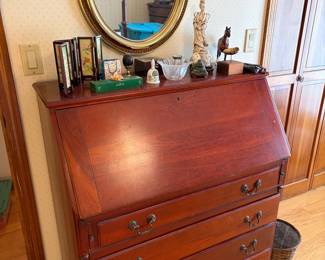 Secretary desk with storage, wall mirror, figurines