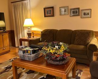 Couch, coffee table, accent rug, art