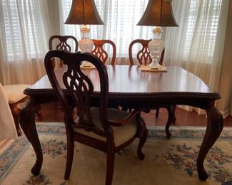 Lovely Queen Anne style dining table with six upholstered chairs, includes six chairs, two leaves, and table pads
