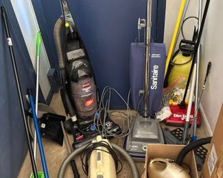 Assorted Vacuum Cleaners and Cleaning Tools