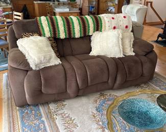 Brown Microfiber Reclining Sofa with Decorative Pillows and Throws