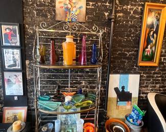 Bakers rack filled with just a few of vintage ashtray and vase collections