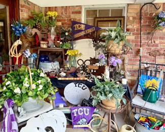 Back patio stuffed full with metal decor, plant stands, holiday.