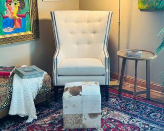White wing back chair with tufted details and black nail head trim