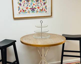 Pair of wood barstools, round wood table , framed colorful textile 