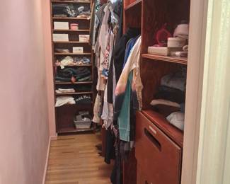 Walk in closet full of designer clothes, shoes and jeans