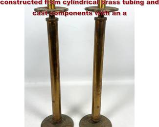 Lot 1806 Pair of tall candlesticks is constructed from cylindrical brass tubing and cast components with an a