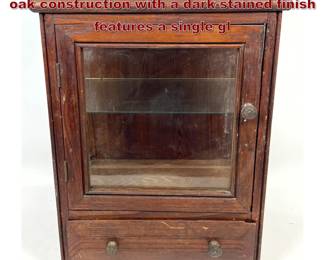 Lot 2249 Antique Tabletop display cabinet of oak construction with a darkstained finish features a single gl