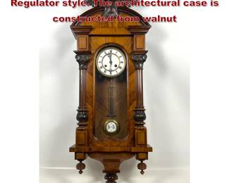 Lot 1899 Antique wall clock in the Vienna Regulator style. The architectural case is constructed from walnut