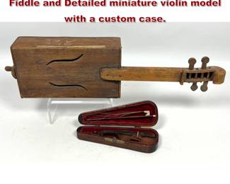 Lot 1898 2 instruments. Folk style Cigar Box Fiddle and Detailed miniature violin model with a custom case.